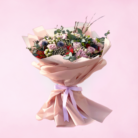 bouquet of mixed flowers wrapped in peach cover