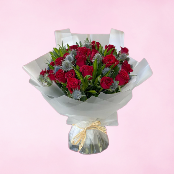 bouquet of red roses with mixed accessories wrapped in white