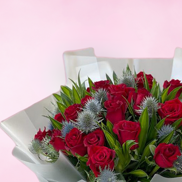 bouquet of red roses with mixed accessories wrapped in white